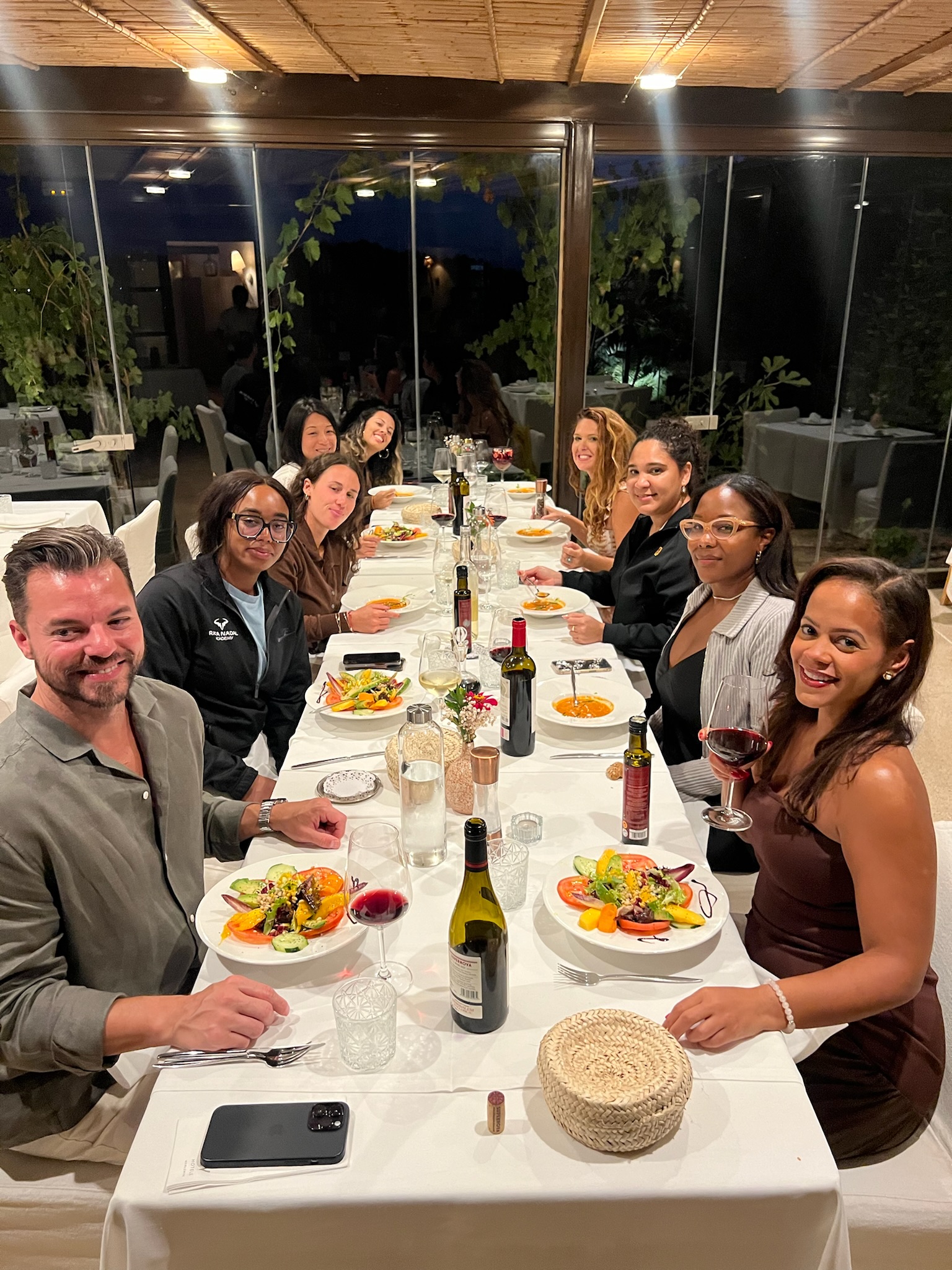 Retreat guests at a long candlelit dinner in Mallorca