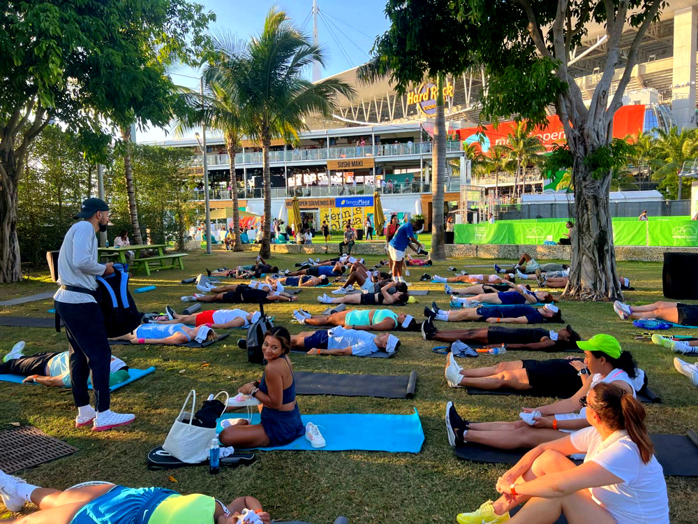 Downward dog on the lawn with Hard Rock Stadium behind